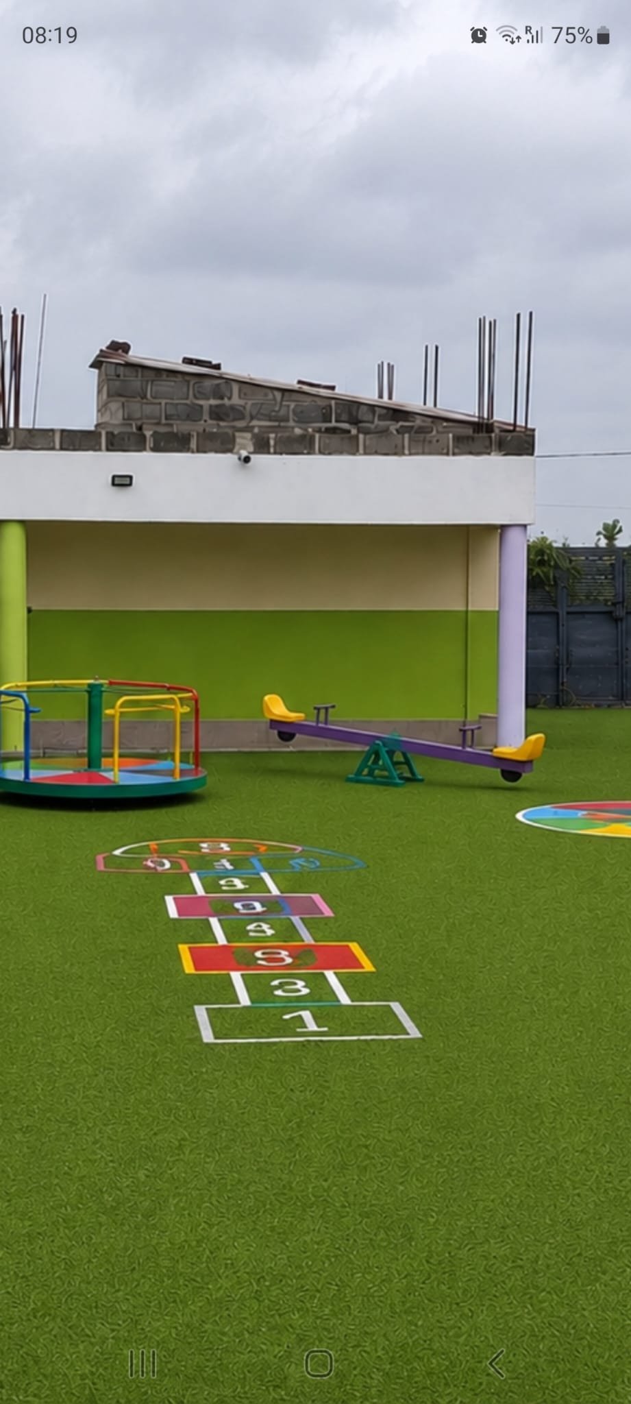 The EBLIS school building and playground, with pupils playing outside